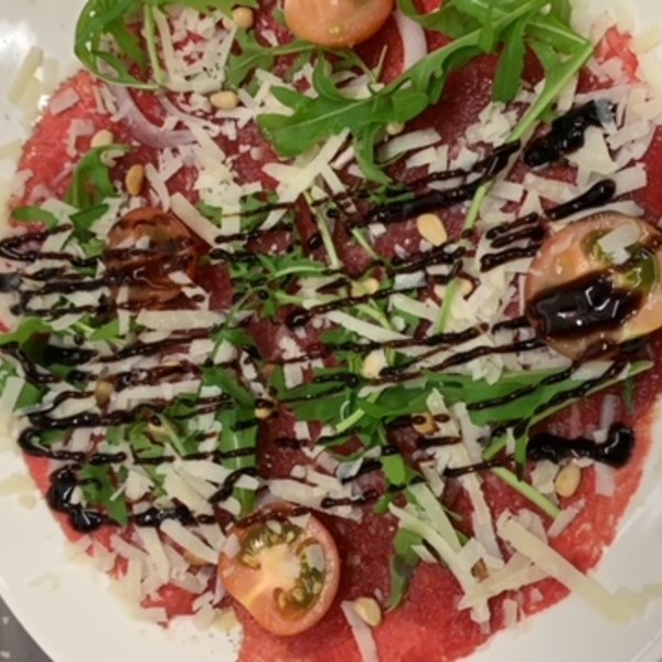 Carpaccio van runds, rucola parmesan